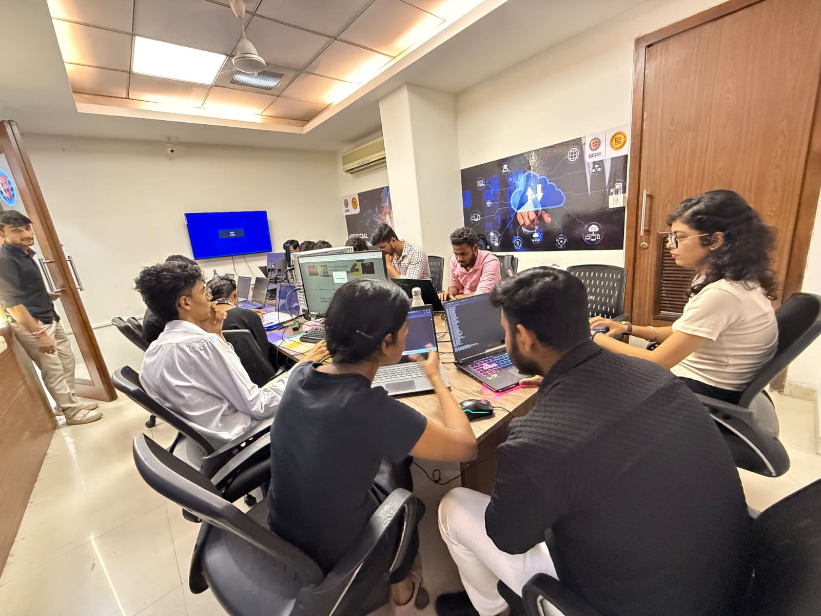 A live training session with a teacher guiding students at computers